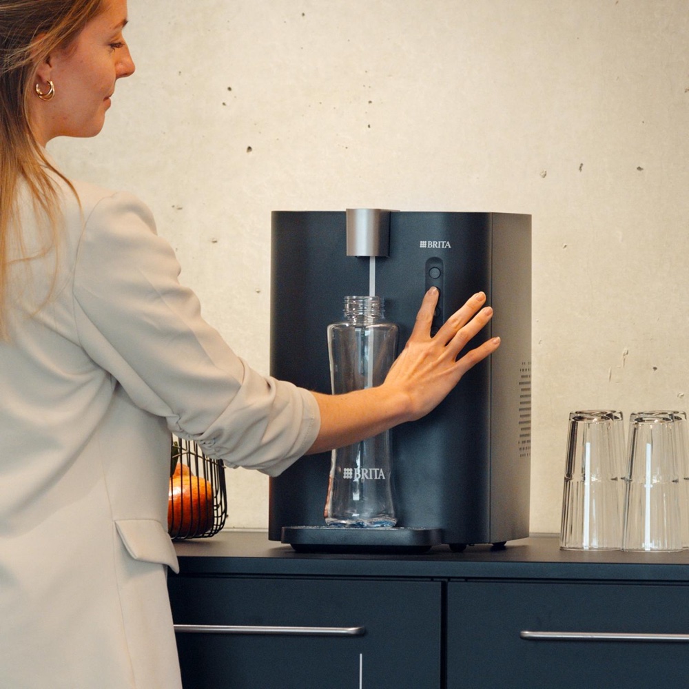 Mains-fed commercial drinking-water dispenser in an office kitchen